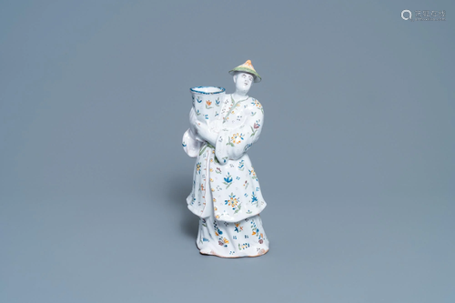 A polychrome French faience candle holder in the shape