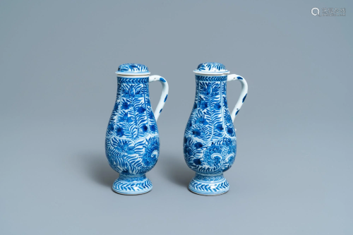 A pair of Chinese blue and white ewers and covers with
