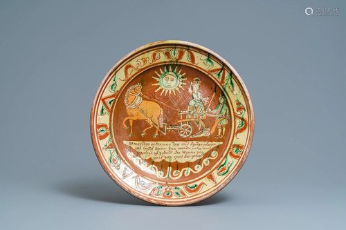 A German slip-decorated inscribed pottery dish with a