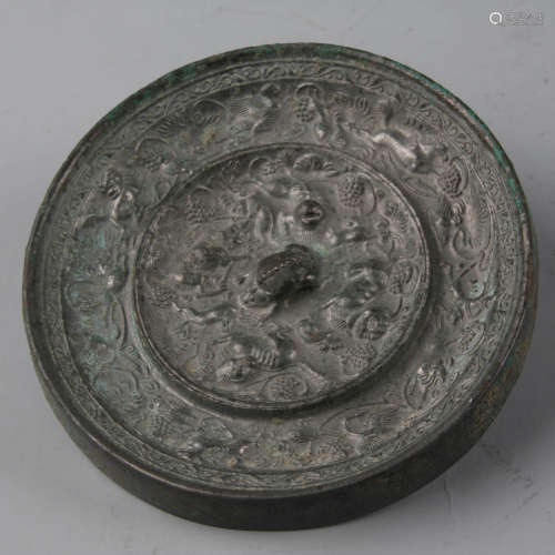 A bronze grapevine and sea-beast circular mirror