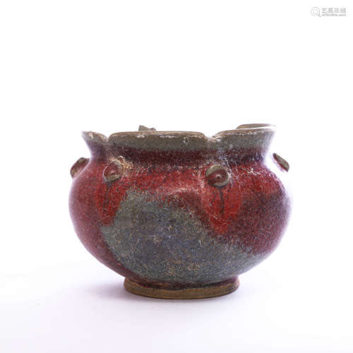 A red-glazed pottery lobed jar