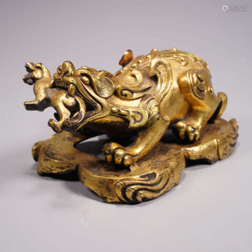 A gilt bronze beast ornament with stand