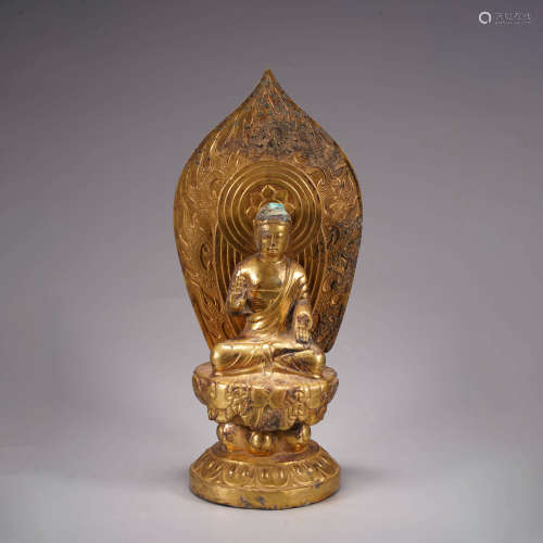 A gilt bronze inscribed buddha statue
