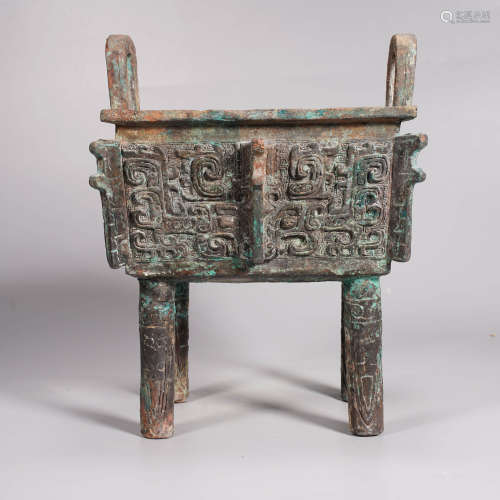 An archaistic style bronze beast-face ding vessel