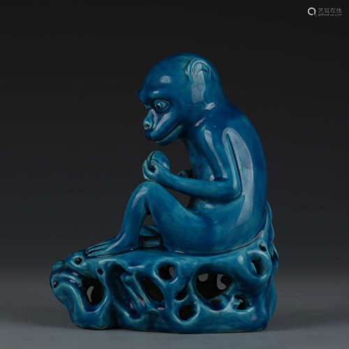 A peacock-blue-glaze pottery monkey ornament