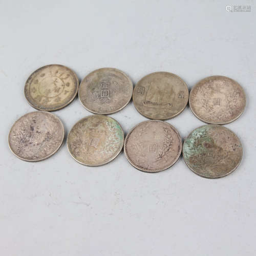 A group of eight chinese silver coins