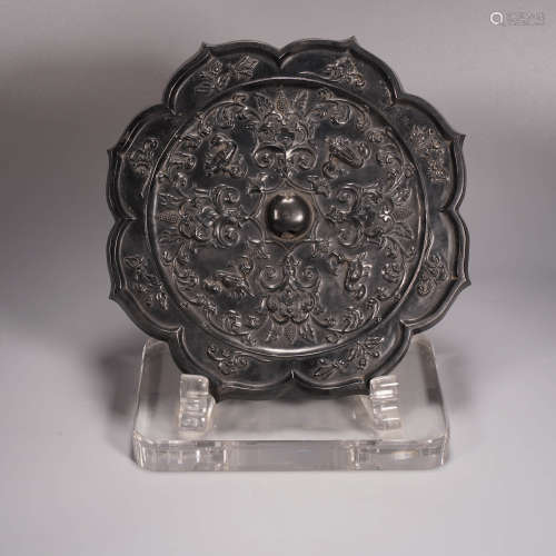 An archaistic style bronze treasure flower barbered-rim mirr...