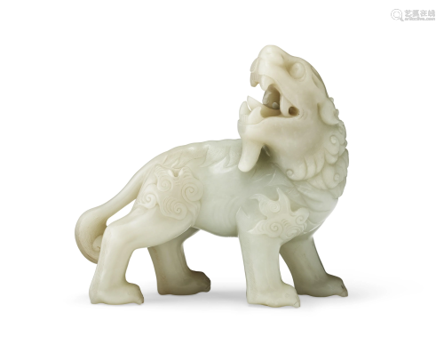 A LARGE PALE GREENISH-WHITE JADE FIGURE OF A LION