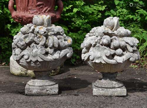 A PAIR OF LIMESTONE FINIALS MODELLED AS FRUITING BASKETS, 20...