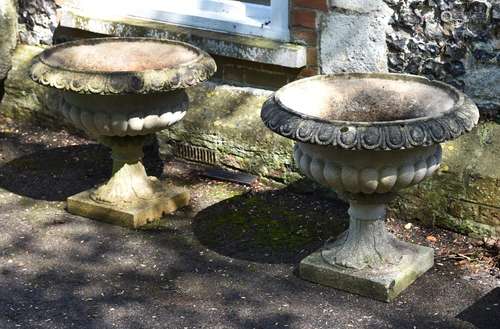 A PAIR OF STONE URNS, IN THE MANNER OF AUSTIN & SEELY, 20TH ...