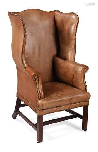 A MAHOGANY AND LEATHER UPHOLSTERED WING ARMCHAIR, CIRCA 1750...