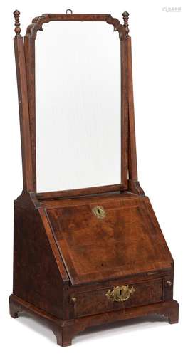 A GEORGE I WALNUT AND FEATHERBANDED DRESSING MIRROR, CIRCA 1...