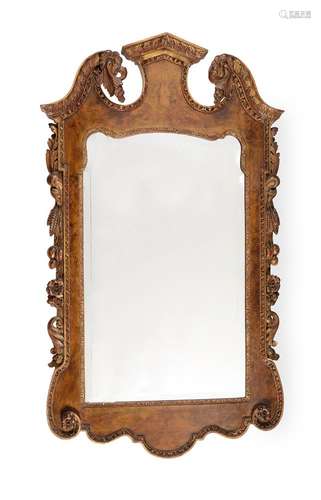 A WALNUT AND PARCEL GILT WALL MIRROR, IN GEORGE II STYLE, LA...