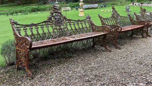 A PAIR OF CAST IRON BENCHES IN THE COALBROOKDALE 'GOTHIC' PA...