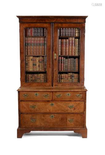 A GEORGE II WALNUT CABINET OR BOOKCASE ON CHEST, CIRCA 1730