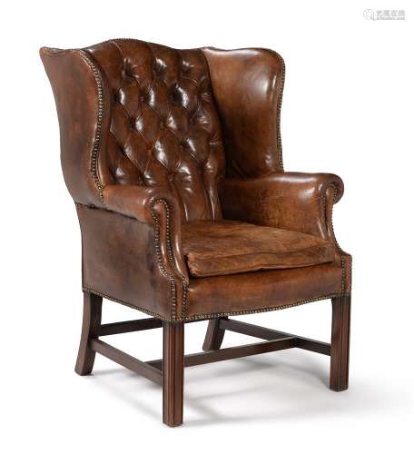 A MAHOGANY AND LEATHER UPHOLSTERED WING ARMCHAIR, 20TH CENTU...