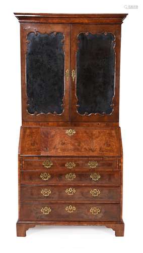 A GEORGE II WALNUT BUREAU BOOKCASE, CIRCA 1740, IN THE MANNE...