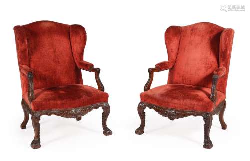 A PAIR OF CARVED WALNUT AND UPHOLSTERED WING ARMCHAIRS, LATE...
