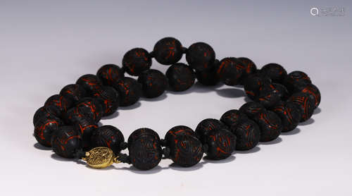 A CHINESE CARVED LACQUER PRAYER BEADS