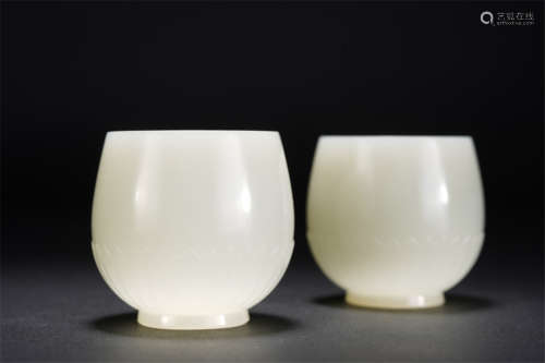 A PAIR OF CHINESE WHITE JADE CARVED LOTUS CUPS