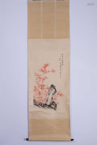 A CHINESE SCROLL PAINTING OF CARMINE RED BAMBOO AND ROCK