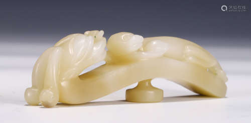 A CHINESE CARVED JADE MYTHICAL BEAST BELT HOOK