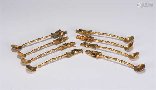 A GROUP OF EIGHT CHINESE GILT BRONZE FIGURAL SPOONS