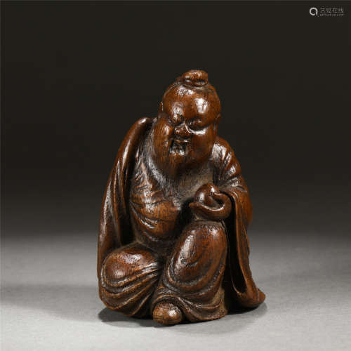 A CHINESE BAMBOO CARVED SEATED FIGURE