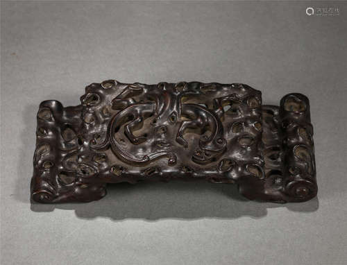 A CHINESE HARDWOOD CARVED BEAST INK REST