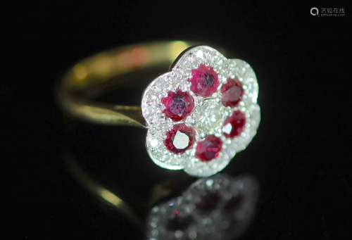 A modern 18ct gold, ruby and diamond set flower head cluster...