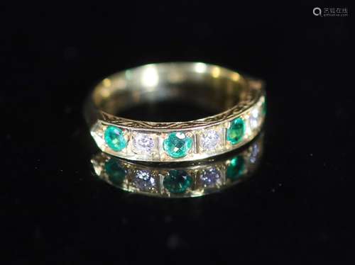 A modern 18ct gold, four stone emerald and three stone diamo...