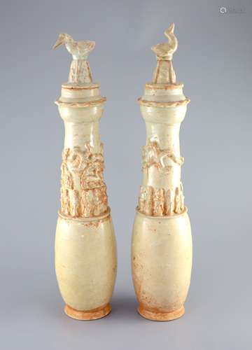 A pair of Chinese pale green glazed funerary vases and cover...