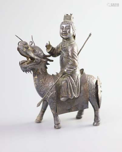 A Chinese white metal model of a boy riding a qilin , early ...