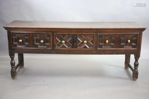 A late 17th century oak dresser,fitted with three geometric ...