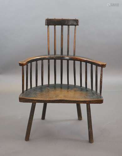 An 18th century primitive vernacular comb-back elbow chair, ...