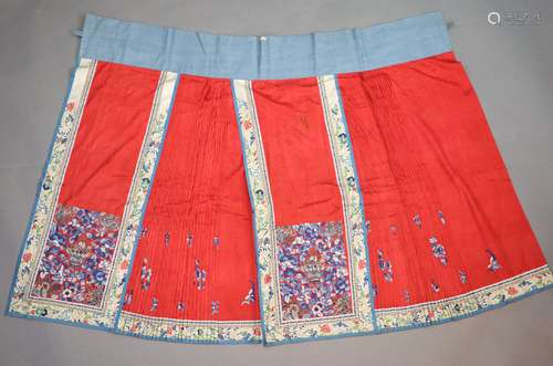 A 19th century Chinese red ground silk skirt,embroidered wit...