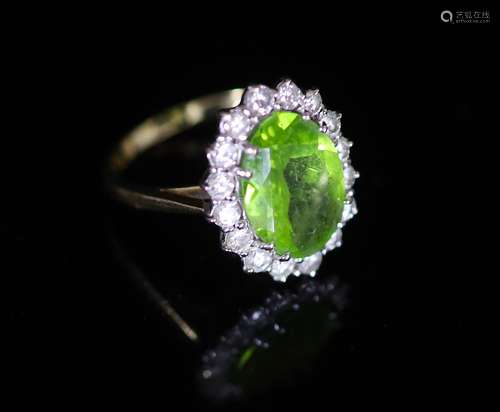 A modern 18ct gold, peridot and diamond set oval cluster rin...