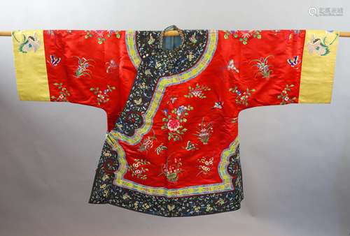 A Chinese red silk robe, early 20th century,embroidered with...