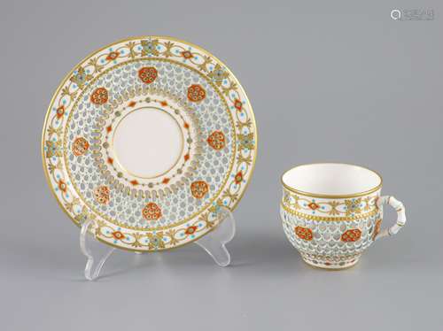 A Royal Worcester 'jewelled' and reticulated cup and saucer,...