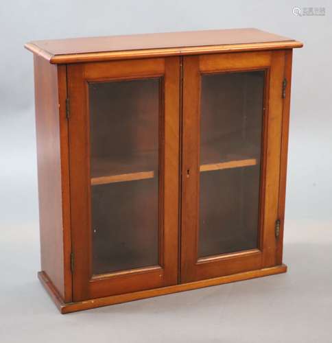 A small Edwardian mahogany wall cabinet,with two glazed door...