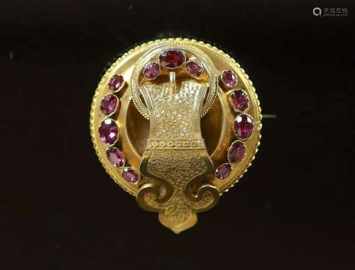 A Victorian gold and garnet set circular 'buckle' brooch,set...