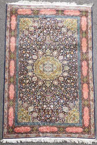 A Persian Kashan wool carpetover a dark blue field.240 x 120...