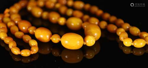 A single strand graduated oval amber bead necklace with roun...