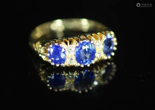 An Edwardian 18ct gold and three stone sapphire set half hoo...