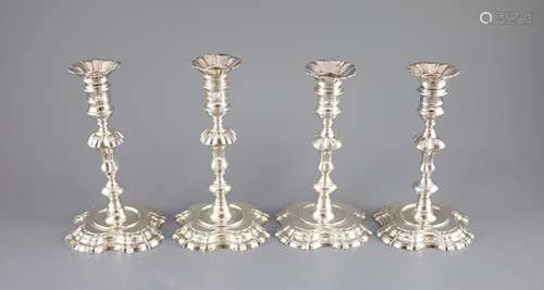 A near set of four George II cast silver candlesticks, by Jo...