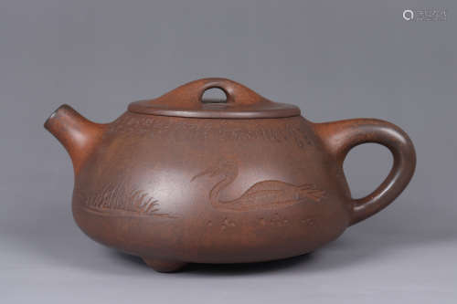 A PURPLE CLAY DUCK TEAPOT WITH SCRIPT