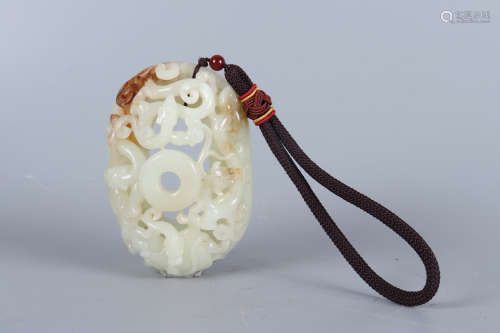 A WHITE AND RUSSET DRAGON JADE PENDANT