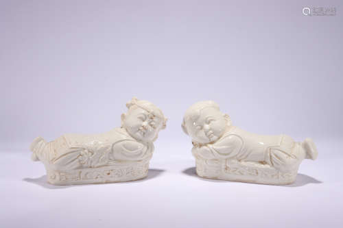 A PAIR OF DING WARE WHITE GLAZED BOY PILLOWS