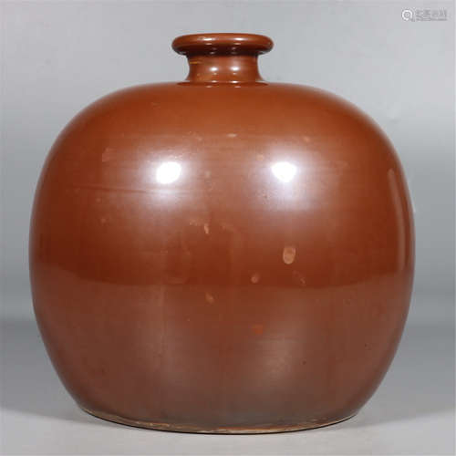 A BROWN-GLAZED OVOID NECKED JAR