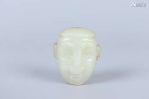 A JADE CARVING OF A FIGURE HEAD